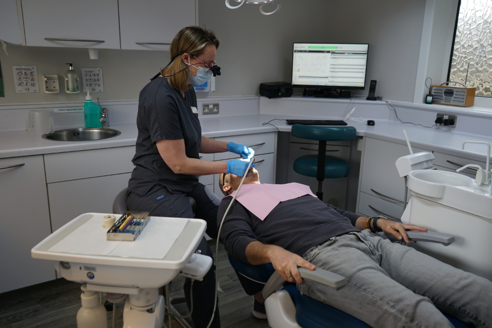 new road dental practice dentist treating patient